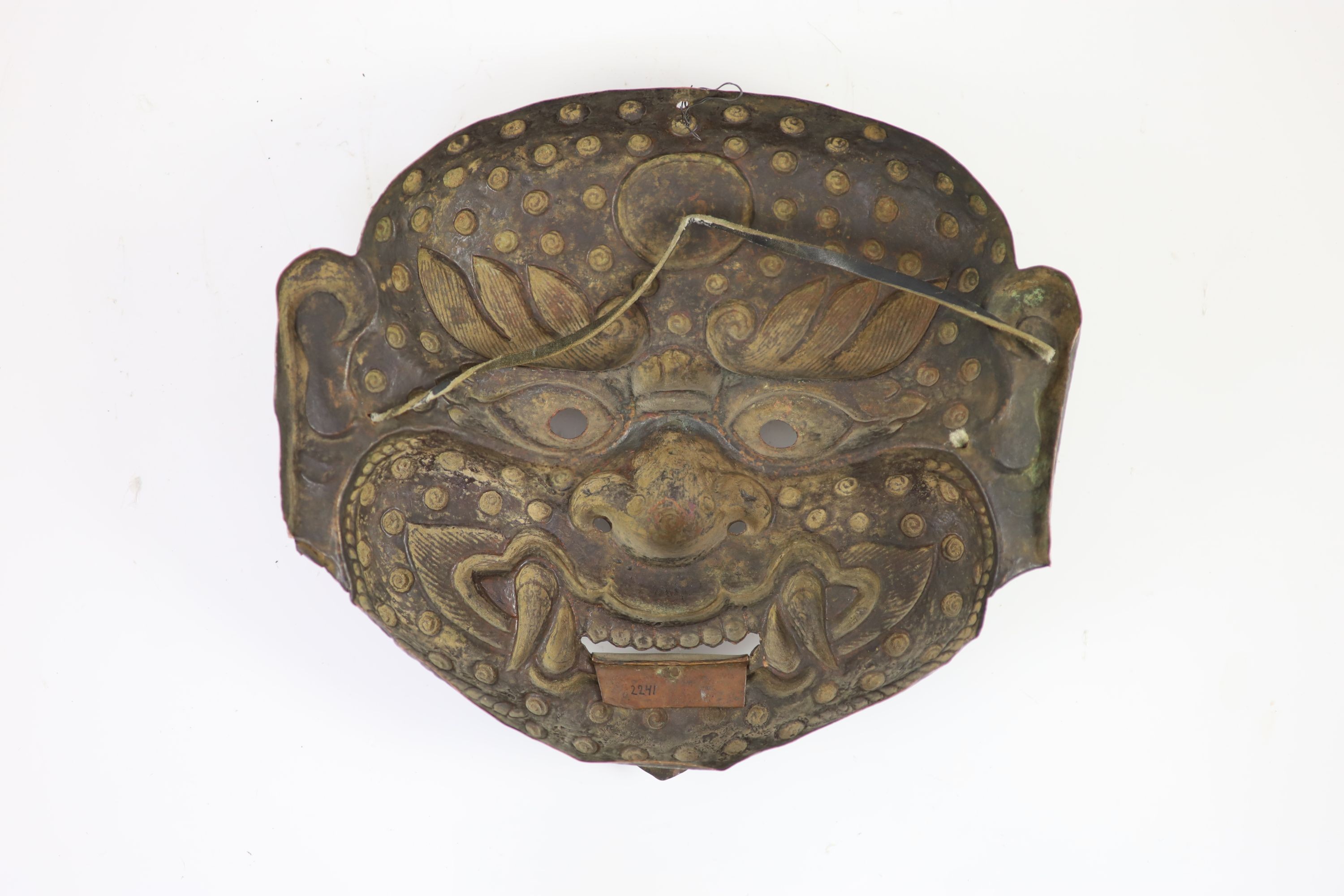 A Tibetan painted repoussé copper ‘demon’ mask, 17th/18th century, 28cm wide, 25cm high